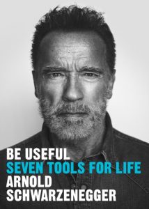A black and white photo of Arnold Schwarzenegger, with his book title printed over: "Be useful: Seven Tools For Life"