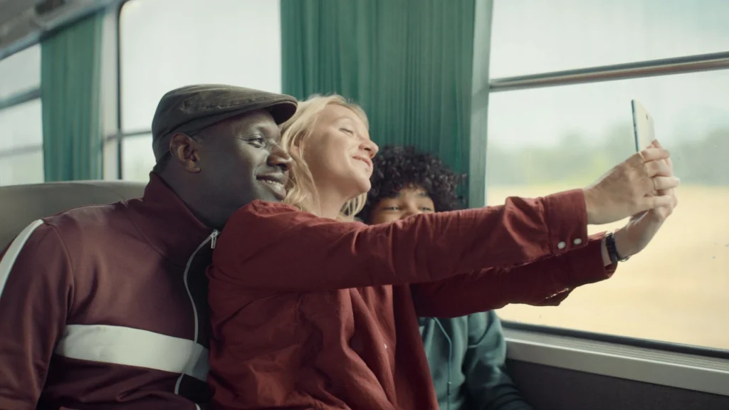 A train ride with Assane, his wife and son. Posing for a selfie, they look happy.