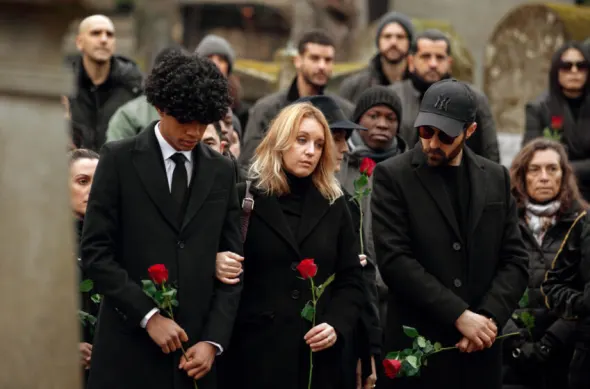 Raoul, Claire, and Ben attending a funeral, mourning graveside with a rose in hand.