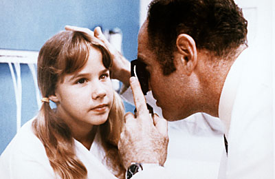 Regan getting a check up by the doctor to see why she is feeling unwell. Eeriness in this picture.