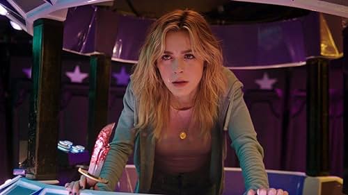 Jamie Hughes, looking angry, scared, and hopeful inside the Quantum Drop fair ride, holding a bloodied knife.