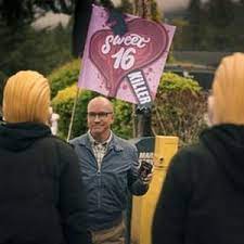 Local journalist protesting to find the Sweet Sixteen Killer from the past, and a mob of Sweet Sixteen Killer fans, dressed up as their idol for Halloween.