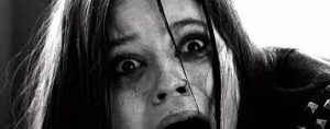 Jenna Ortega, scream queen, screaming in a black and white still photo from the Studio 666 movie
