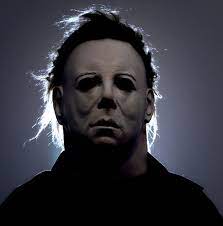 Michael Myer's mask in the dark with moonlight shining behind him
