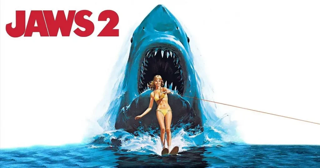 The Jaws 2 poster, from 1978. A woman is water skiing, not realising that the shark is behind her.